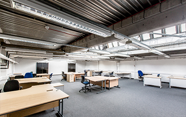 Air conditioned work spaces with break out area with desks, chairs, pedestals, VoIP handsets, WIFI and water coolers